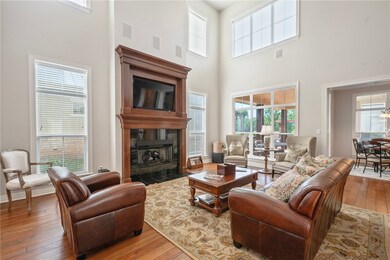 Living room with hardwood / wood-style flooring, a