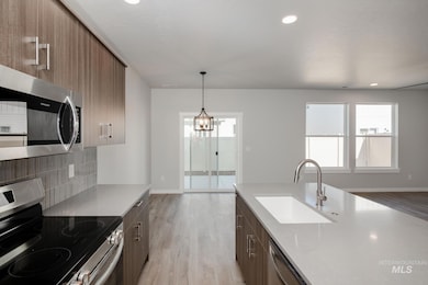 Kitchen with appliances with stainless steel finishes, light wood-style floors, light countertops, modern cabinets, and recessed lighting