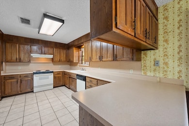 Kitchen features wood cabinetry!