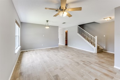Unfurnished living room with stairway, a ceiling 