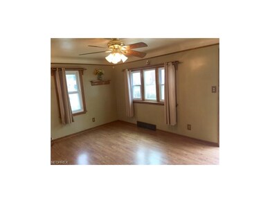 Living Room has shiny laminate (Pergo) Flooring (2002), easy care Vinyl windows (1999), Ceiling fan/light, all Trim molding on first floor replaced with Oak in 1998.