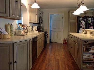 The beautiful kitchen with corian counters and lots of storage. The other side of the counter is a full bar seating area. 