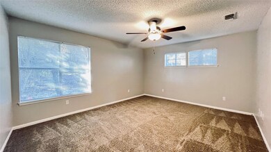 Unfurnished room featuring a ceiling fan, carpet 