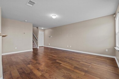 Unfurnished room featuring baseboards, wood finis