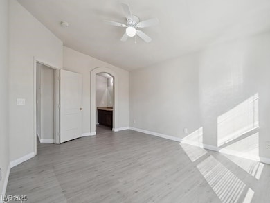 Unfurnished room with baseboards, arched walkways,