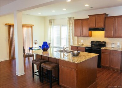 Another angle of open kitchen, island and eating a