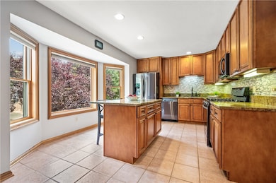 The beautiful kitchen is spacious and pristine. It