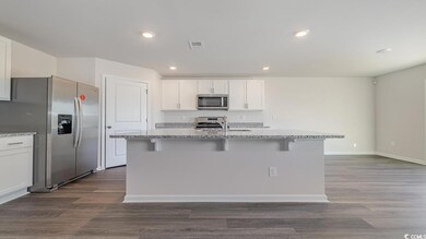 Kitchen with stainless steel appliances, white cab