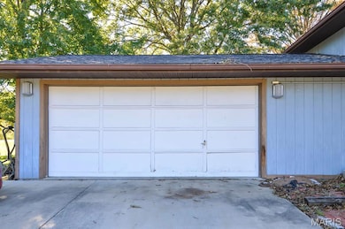 Garage featuring concrete driveway