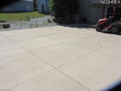 There is a ooncrete patio in the lower level.