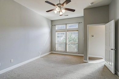 The primary bedroom offers ample space, natural li