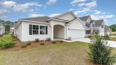 View of front of home with concrete driveway, roof
