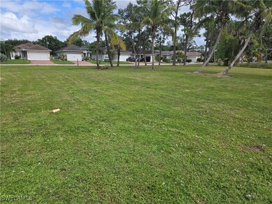 View of green lawn with a residential view