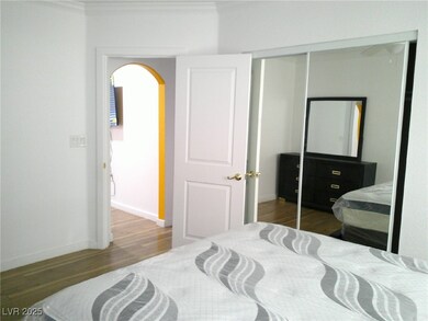 Bedroom featuring arched walkways, crown molding,