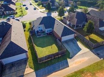 Another aerial view showing large fenced yard and 
