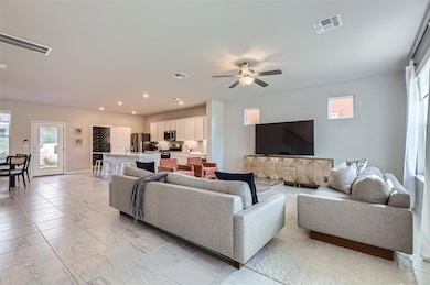 Living area featuring light marble finish floors,