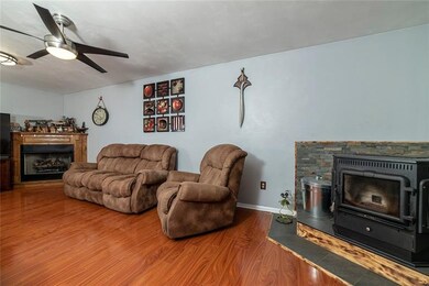 FAMILY ROOM WITH GAS FIREPLACE AND 4-FUEL STOVE.