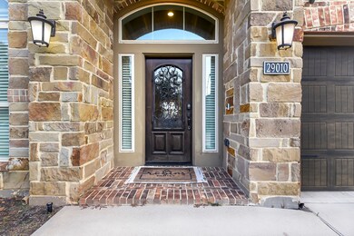 The welcoming front patio features charming brick flooring, creating a warm and inviting space.