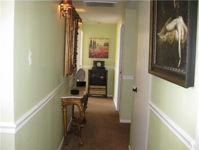 Charming hallway leading to the bedrooms and baths