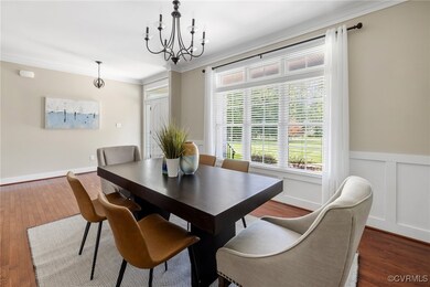 Dining room with a chandelier, crown molding, and