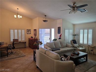 Tiled living room featuring a ceiling fan, lofted
