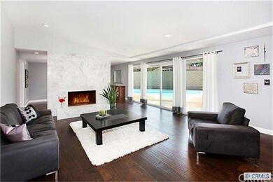 Oversized living room with tall doors opening to t