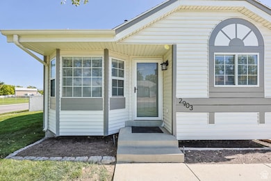 View of exterior entry with a yard
