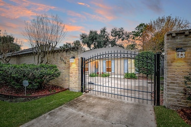 Nestled behind a welcoming driveway gate and under gorgeous trees...