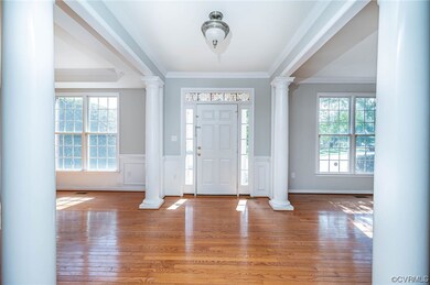 Entrance foyer featuring ornate columns, crown mol