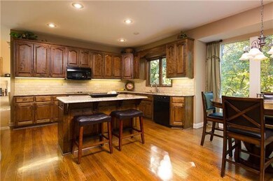 Large kitchen with island, beautiful wood floors a