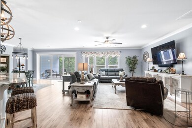 Living room featuring ceiling fan with notable cha