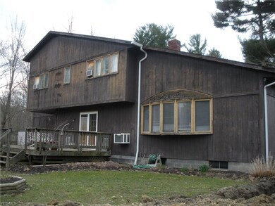 Back of home.  Again, in need of siding/repair.  D