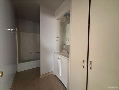 Bathroom with tile patterned floors and vanity