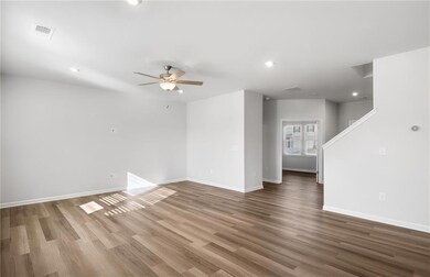 Spare room featuring wood finished floors, baseboards, a ceiling fan, and recessed lighting
