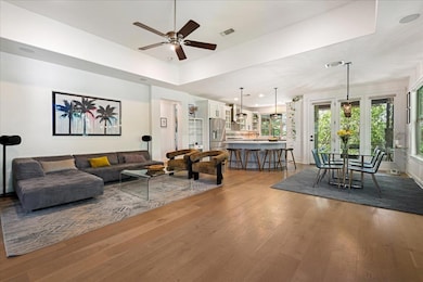 Living room with wood-type flooring, visible vent