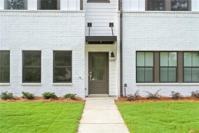 Property entrance featuring brick siding and a yar