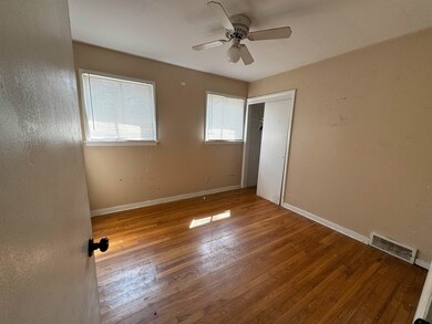 Spare room with wood-type flooring and ceiling fan