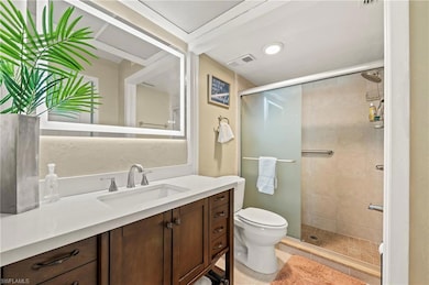 Full bath featuring visible vents, a shower stall, toilet, vanity, and tile patterned flooring