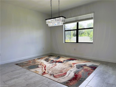 Unfurnished room featuring a chandelier and wood finished floors