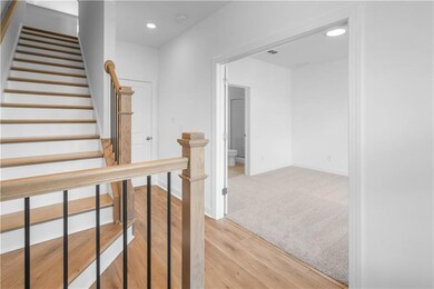 Coming in the front door - hard surface flooring and bedroom with cushiony carpet, double doors and private bathroom - *pictures represent a previously built home * photos are for representation only
