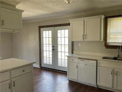 Kitchen with dishwasher, a sink, french doors, hea