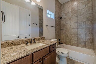 Bathroom with vanity, shower / washtub combinatio
