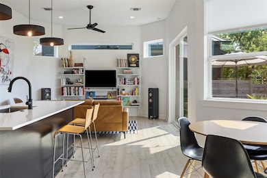 Dining area with a ceiling fan, recessed lighting