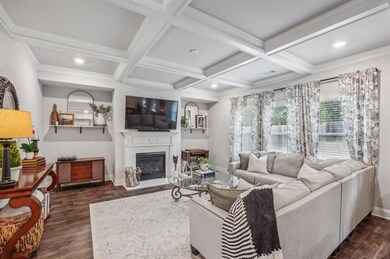 Stunning Family Room With A Fireplace & Coffered C
