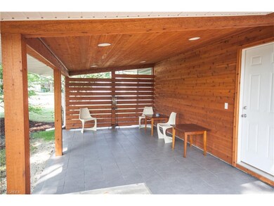 Cedar-planked porch with slate tile flooring--priv
