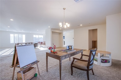 Home office with light colored carpet, recessed li