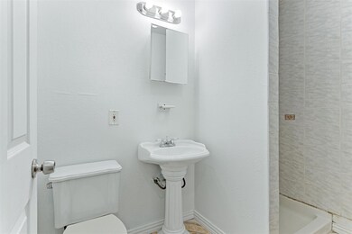 Bathroom featuring sink, toilet, and walk in showe