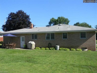 The backyard features a patio and a shed and plent