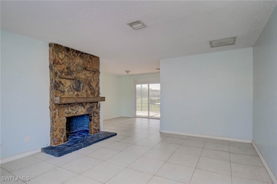 Unfurnished living room with a textured ceiling, b