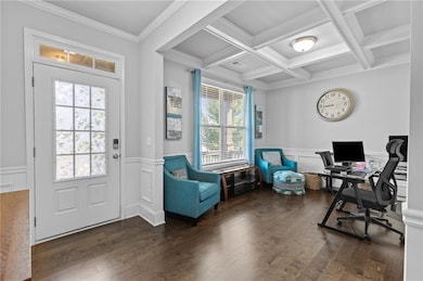 Office space with wood finished floors, beamed ceiling, wainscoting, ornamental molding, and coffered ceiling